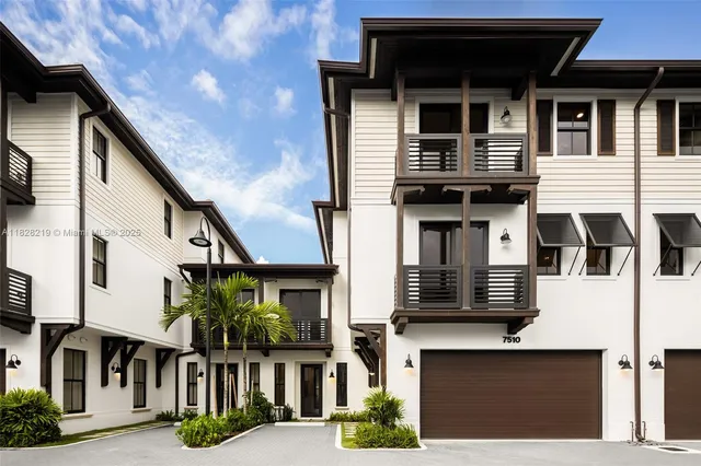 a front view of residential houses with stairs