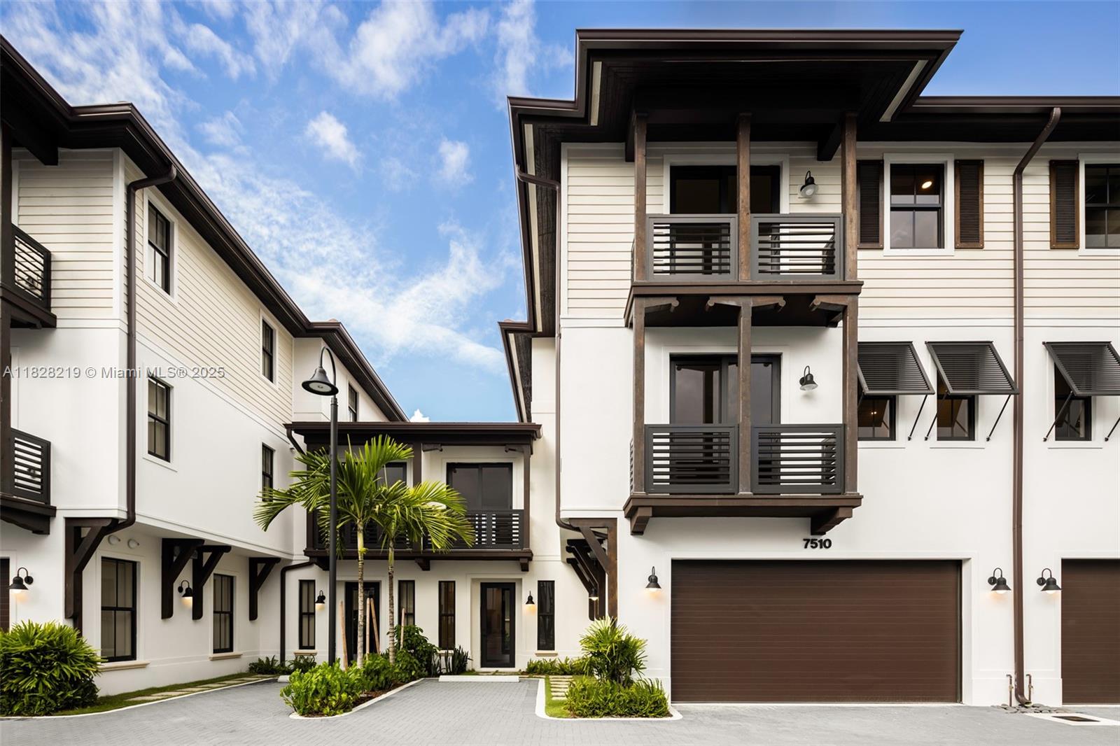 7510 Southwest 100th Street, Unit 12 Pinecrest, FL 33156 - Photo 1 of 36 a front view of residential houses with stairs