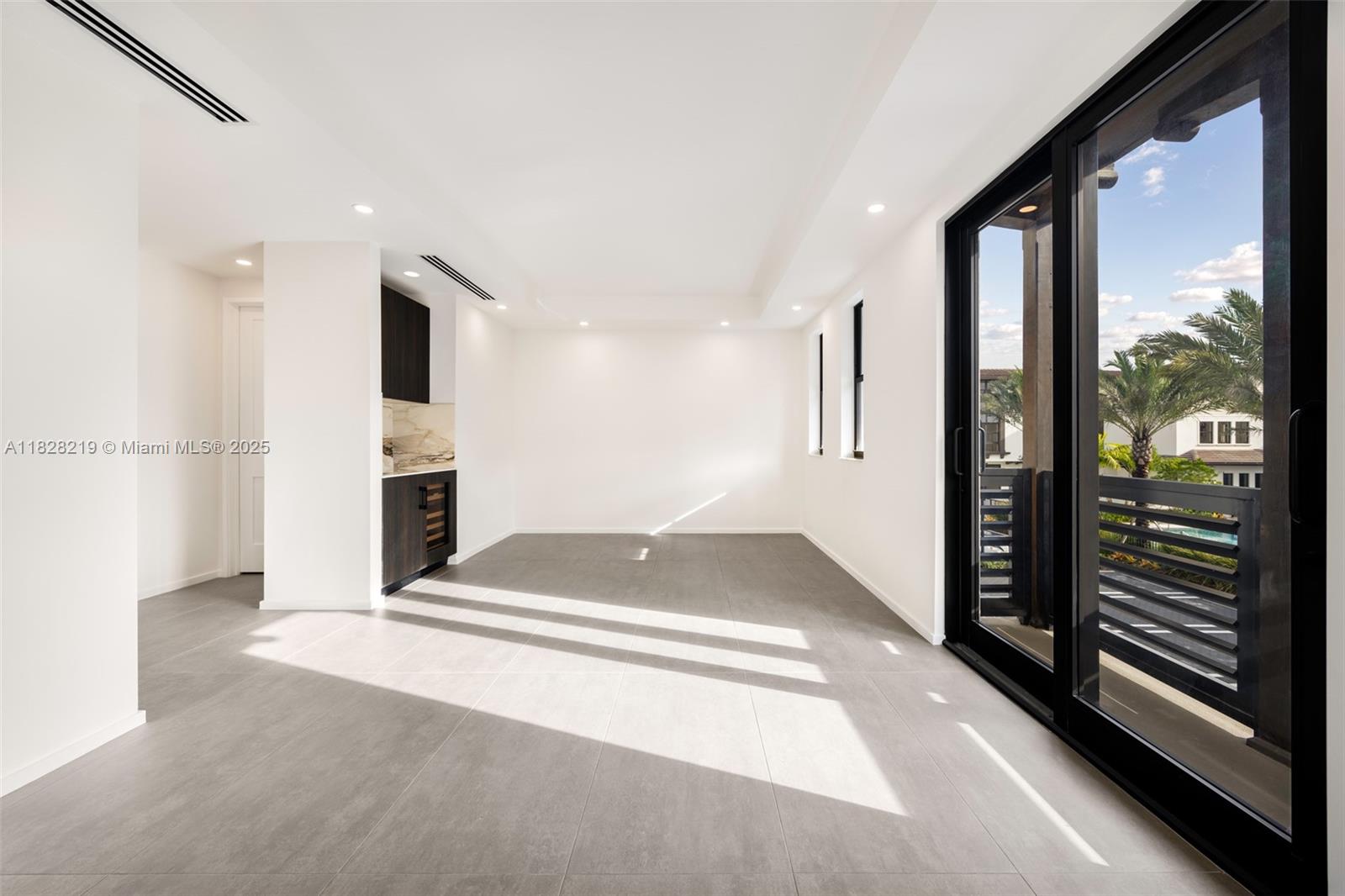 7510 Southwest 100th Street, Unit 12 Pinecrest, FL 33156 - Photo 15 of 36 a living room with a fireplace furniture and a large window