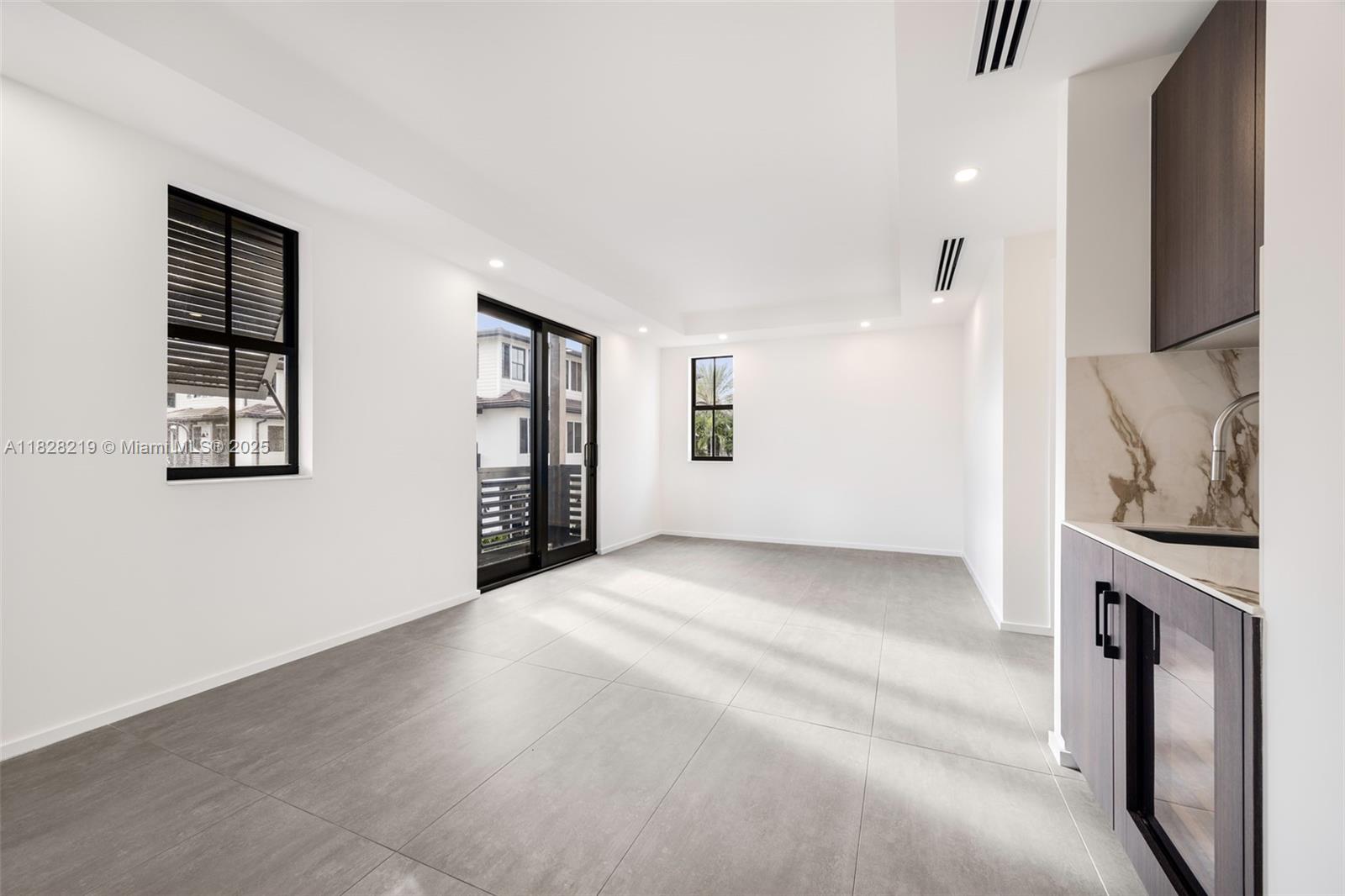 7510 Southwest 100th Street, Unit 12 Pinecrest, FL 33156 - Photo 16 of 36 a view of a kitchen with an entryway and a fireplace