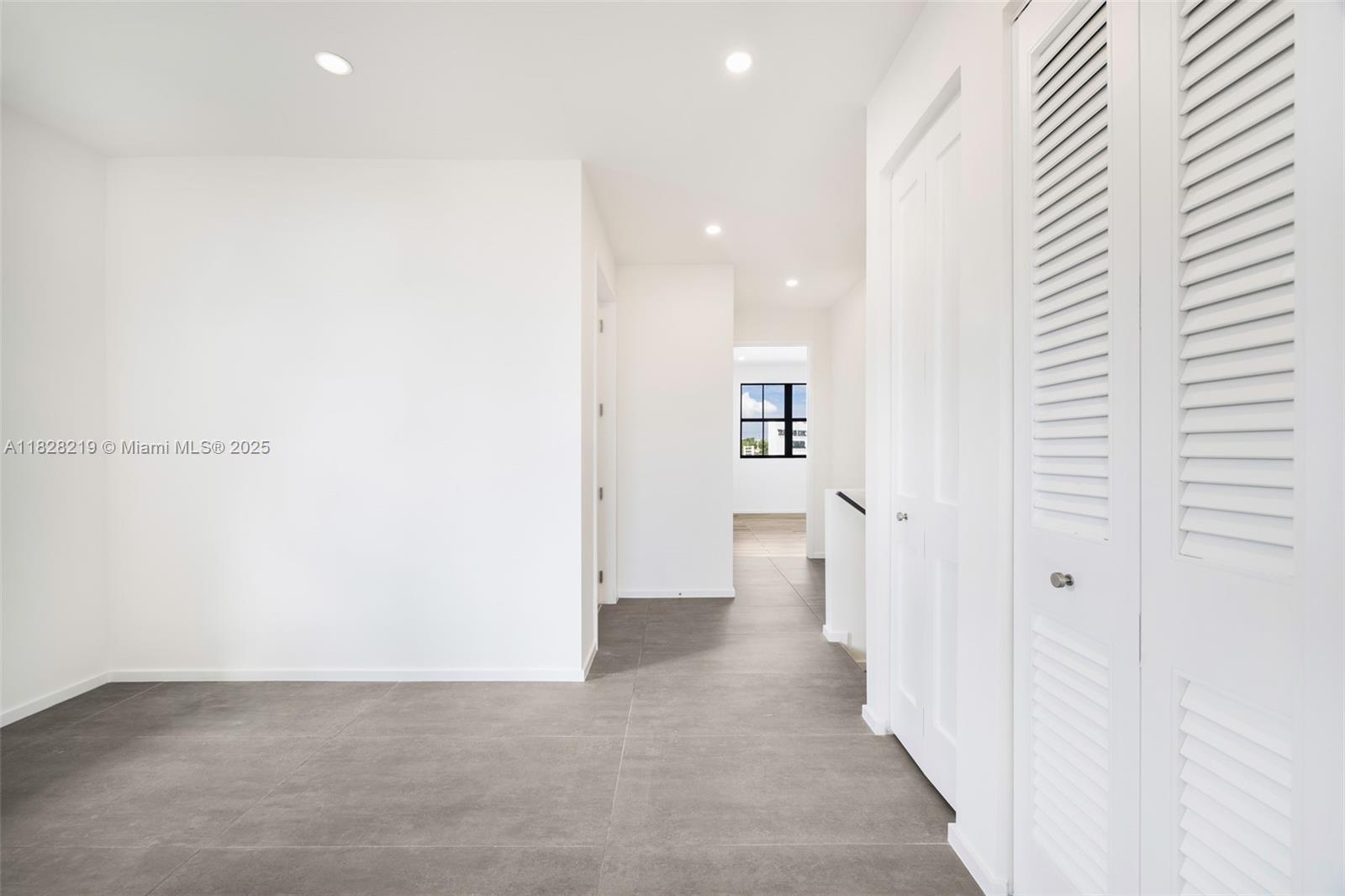 7510 Southwest 100th Street, Unit 12 Pinecrest, FL 33156 - Photo 17 of 36 a view of a hallway with wooden shelves