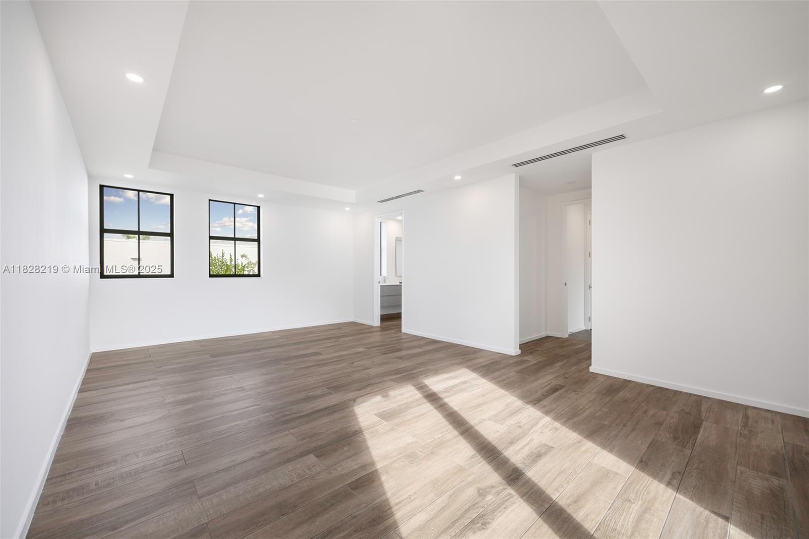 7510 Southwest 100th Street, Unit 12 Pinecrest, FL 33156 - Photo 25 of 36 a view of empty room with wooden floor and fan