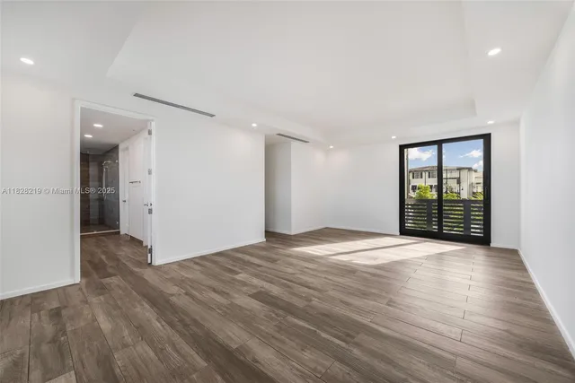 a view of a room with wooden floor and a sink