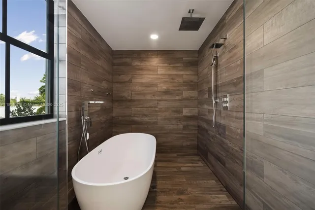 a bathroom with a sink mirror toilet and next to a large window