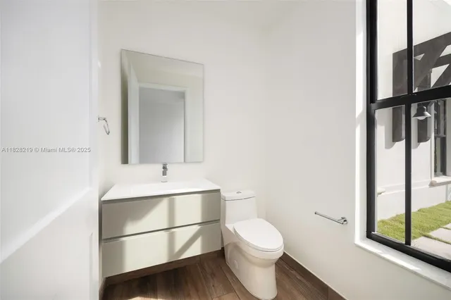 a bathroom with a sink toilet and mirror
