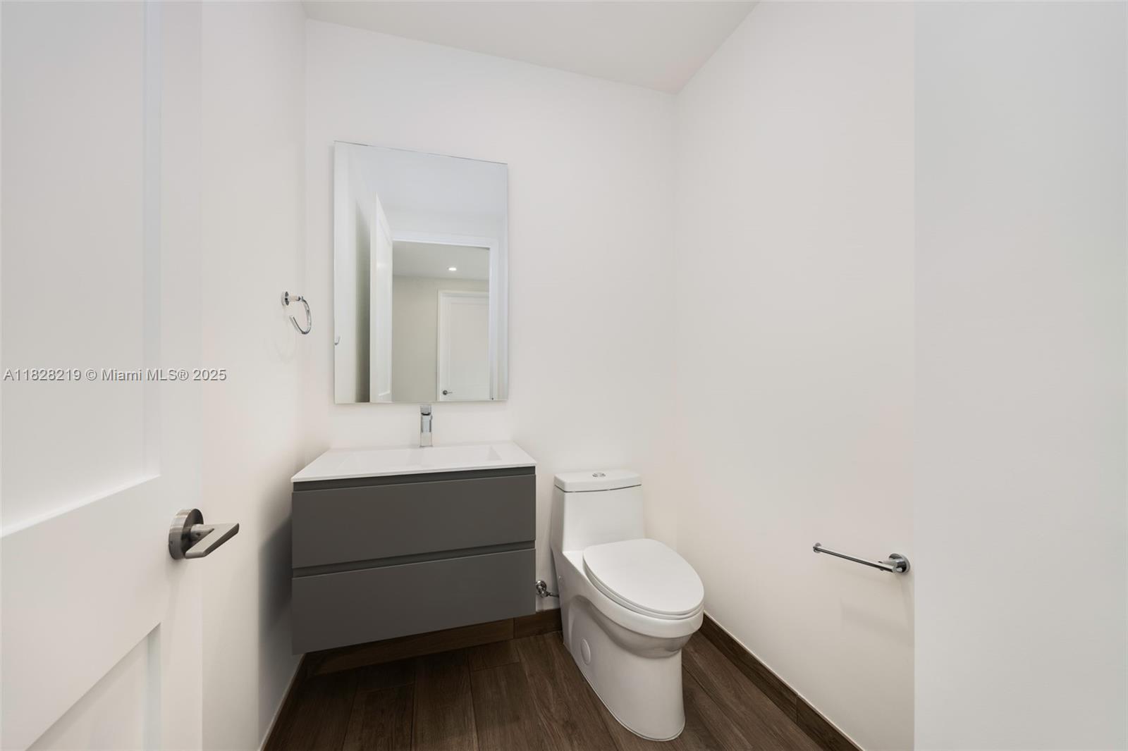 7510 Southwest 100th Street, Unit 12 Pinecrest, FL 33156 - Photo 35 of 36 a bathroom with a sink toilet and mirror