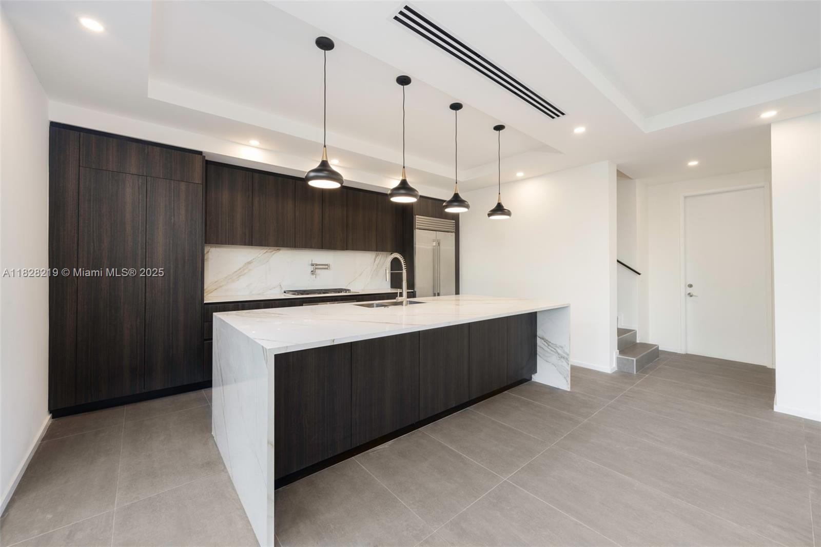 7510 Southwest 100th Street, Unit 12 Pinecrest, FL 33156 - Photo 5 of 36 a kitchen with kitchen island a sink stainless steel appliances and cabinets