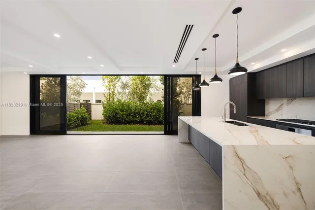 a large white kitchen with a large window