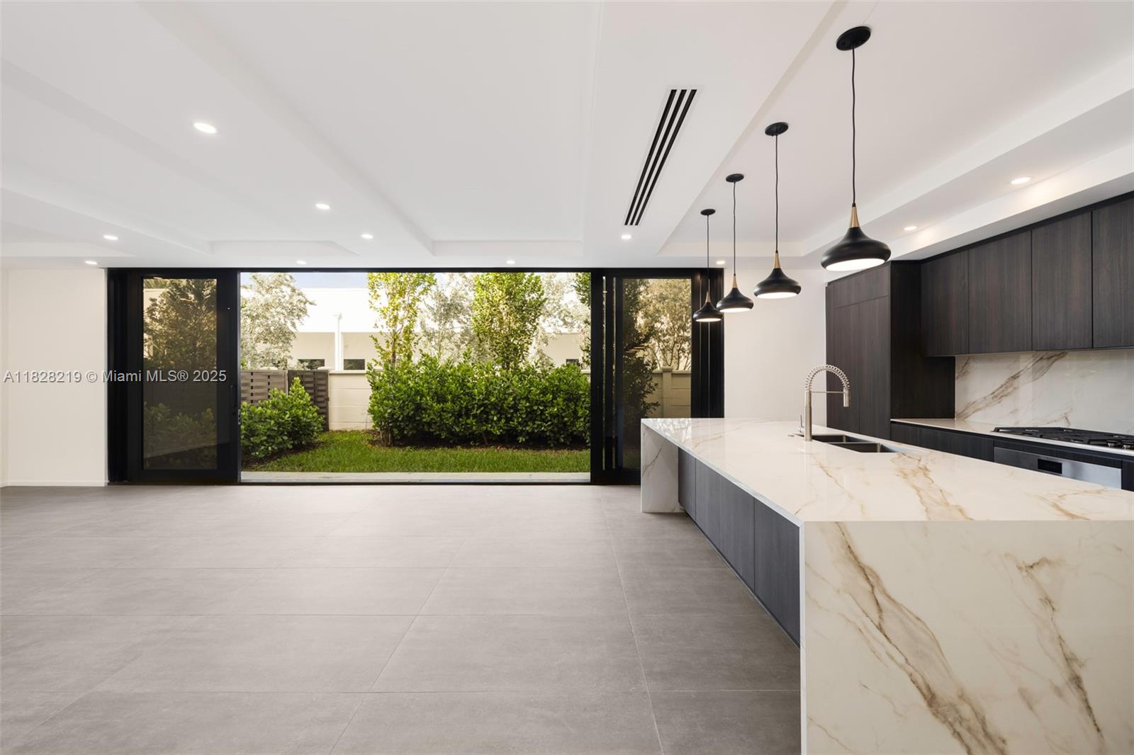 7510 Southwest 100th Street, Unit 12 Pinecrest, FL 33156 - Photo 9 of 36 a large white kitchen with a large window