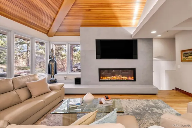 a kitchen with stainless steel appliances kitchen island granite countertop a stove a sink a dining table and chairs