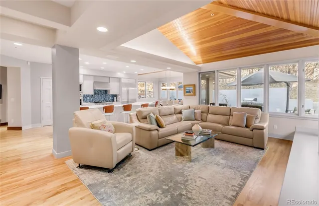 a view of a dining room with furniture large windows and wooden floor