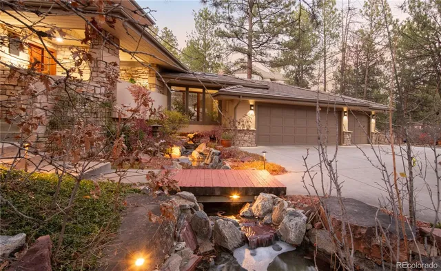 a view of a patio with table and chairs with wooden fence and plants