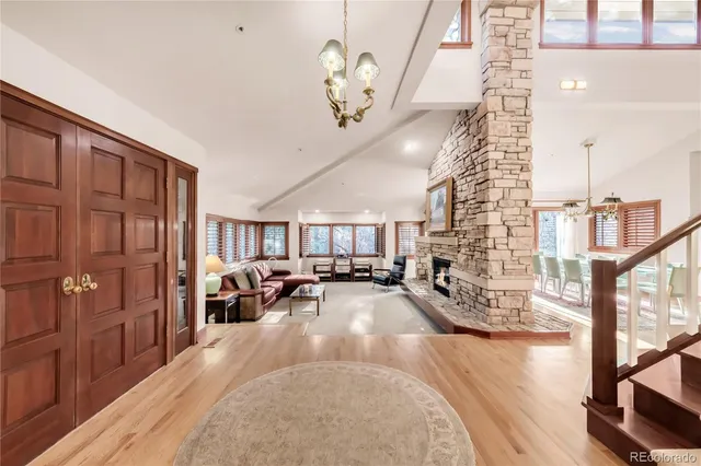 a living room with furniture fireplace and a large window