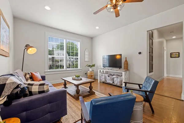 a living room with furniture and a flat screen tv