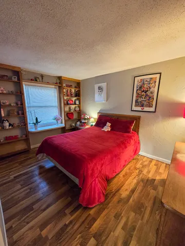 a bedroom with a large bed and a book shelf