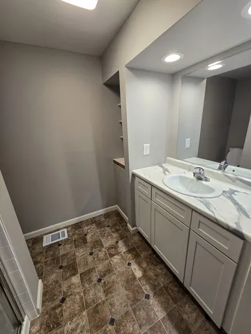 a bathroom with a sink and a mirror