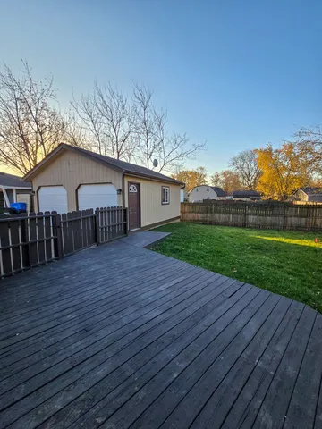 a front view of a house with yard and green space