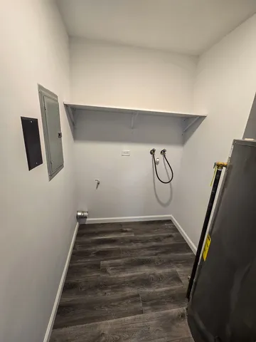 a view of a room with wooden floor and white walls