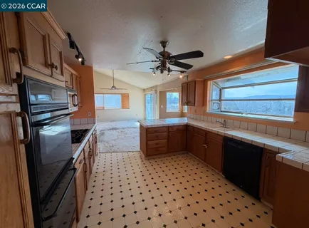 a kitchen with stainless steel appliances a sink a stove a refrigerator and cabinets