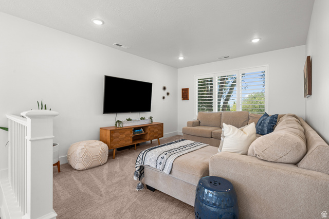 2706 West Maple Street, Unit 285 Mapleton, UT 84664 - Photo 14 of 36 Carpeted secondary living space featuring a wall-mounted display, recessed lighting, and white plantation shutters