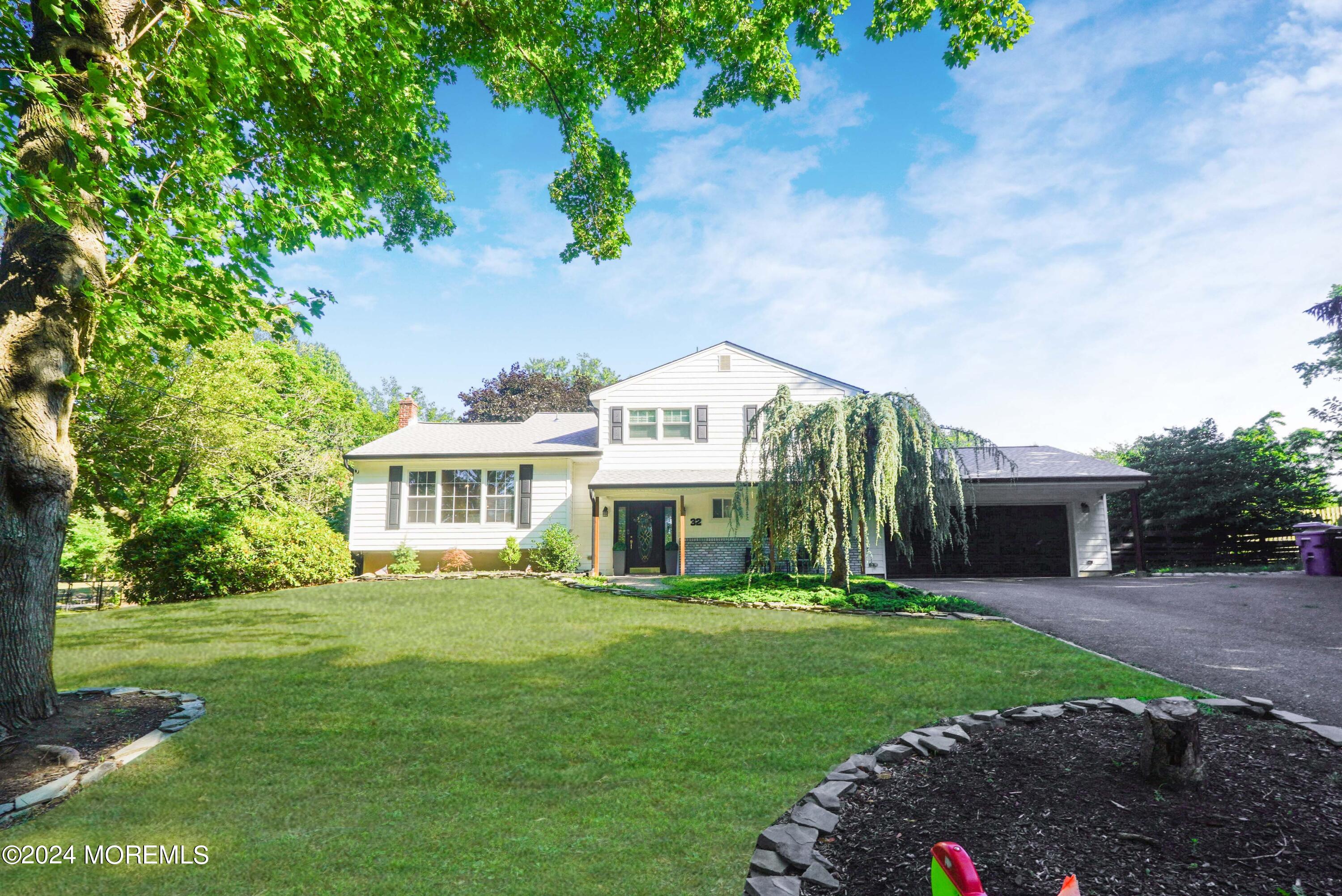 32 Crest Road Middletown, NJ 07748 - Photo 5 of 52 a front view of a house with a garden