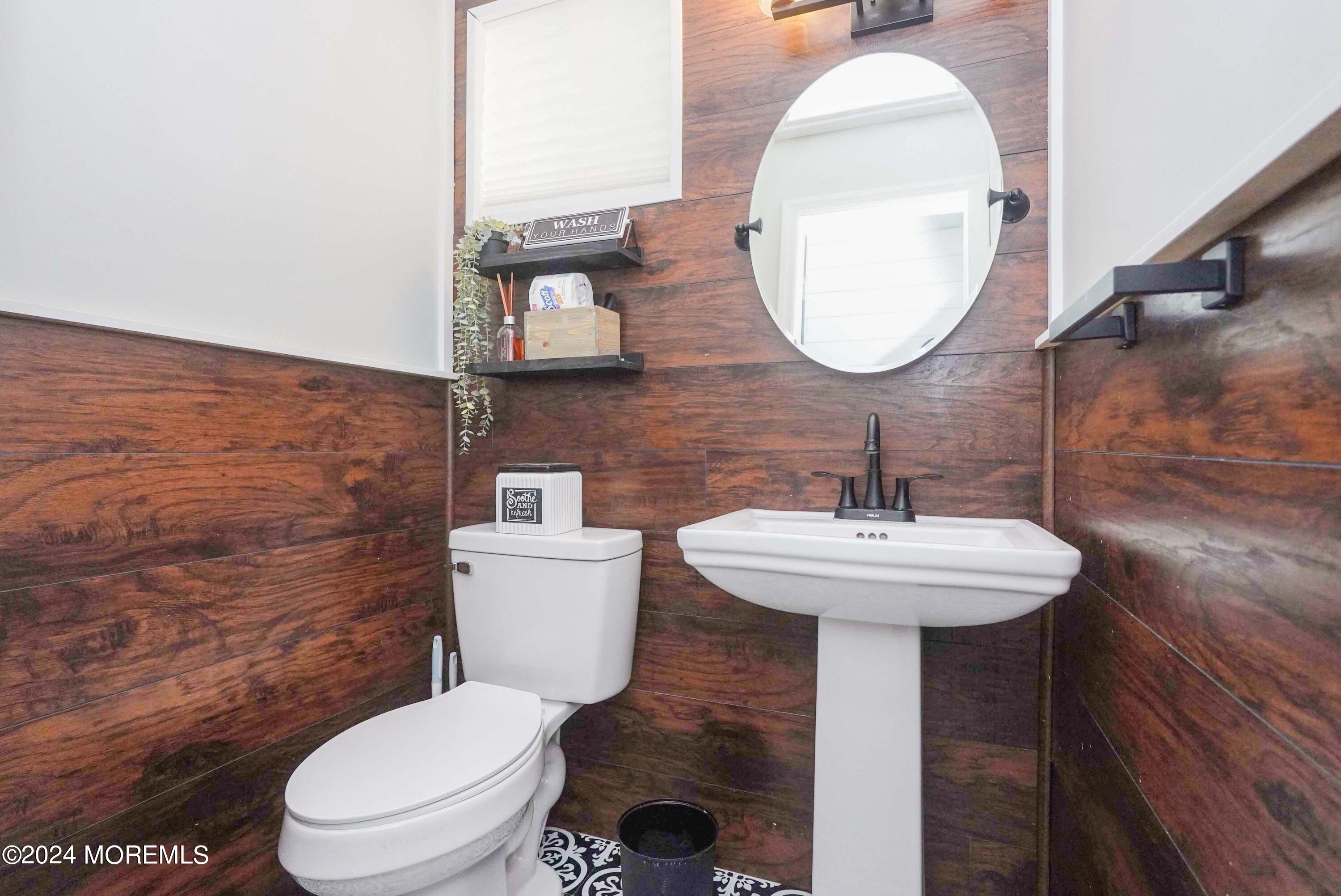 32 Crest Road Middletown, NJ 07748 - Photo 8 of 52 a bathroom with a toilet a sink and mirror