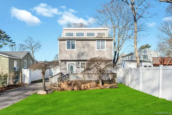 a view of a house with a yard and sitting area