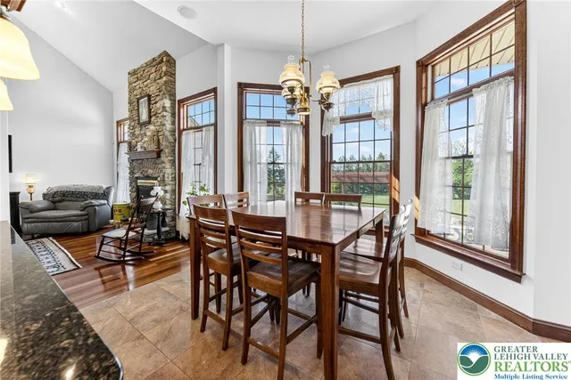 a view of a dining room with furniture large window and chandelier