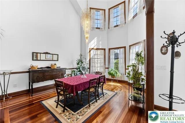 a dining room with furniture and wooden floor