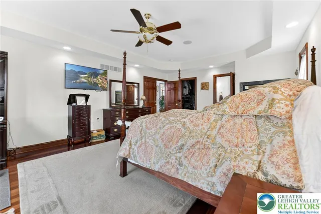 a view of a living room with wooden floor and painting on the wall