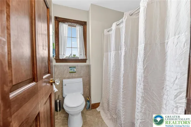 a view of a house with a yard and potted plants
