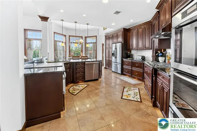 a kitchen with stainless steel appliances granite countertop a stove and a sink