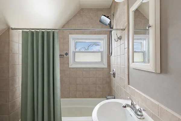 a bathroom with a sink mirror and toilet