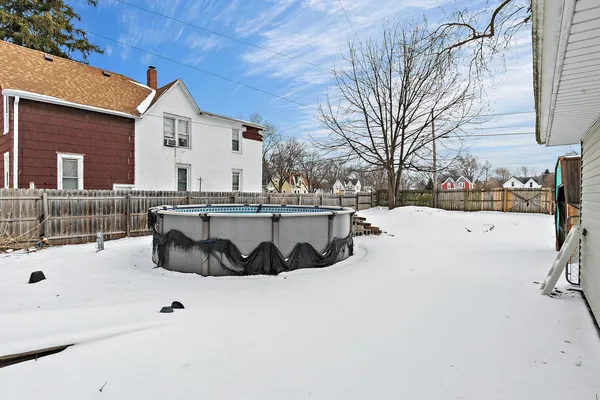 a view of a house with snow on the road