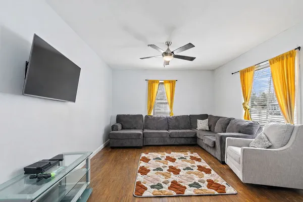a living room with furniture and a flat screen tv