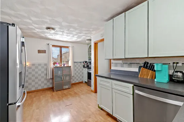 a kitchen with stainless steel appliances granite countertop a refrigerator and a sink