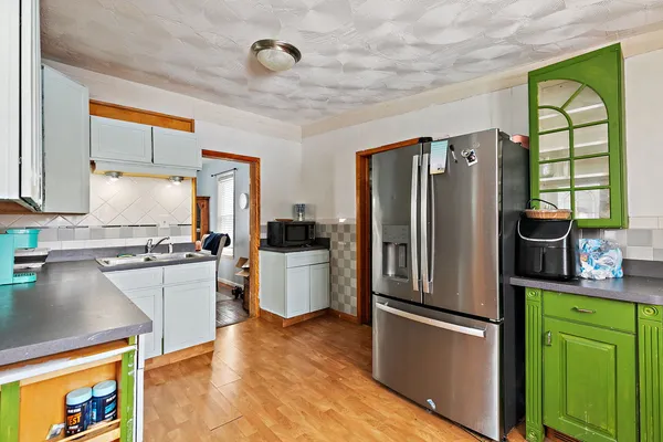 a kitchen with a refrigerator and a sink