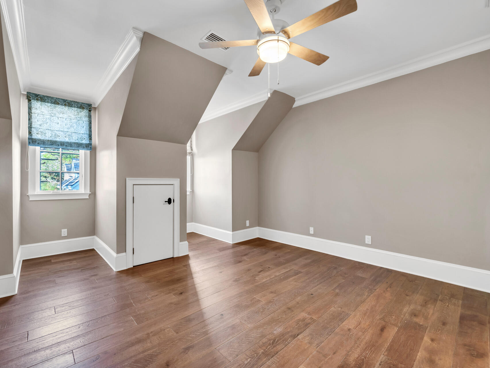 182 Buck Road Santa Rosa Beach, FL 32459 - Photo 45 of 99 an empty room with wooden floor chandelier fan and windows