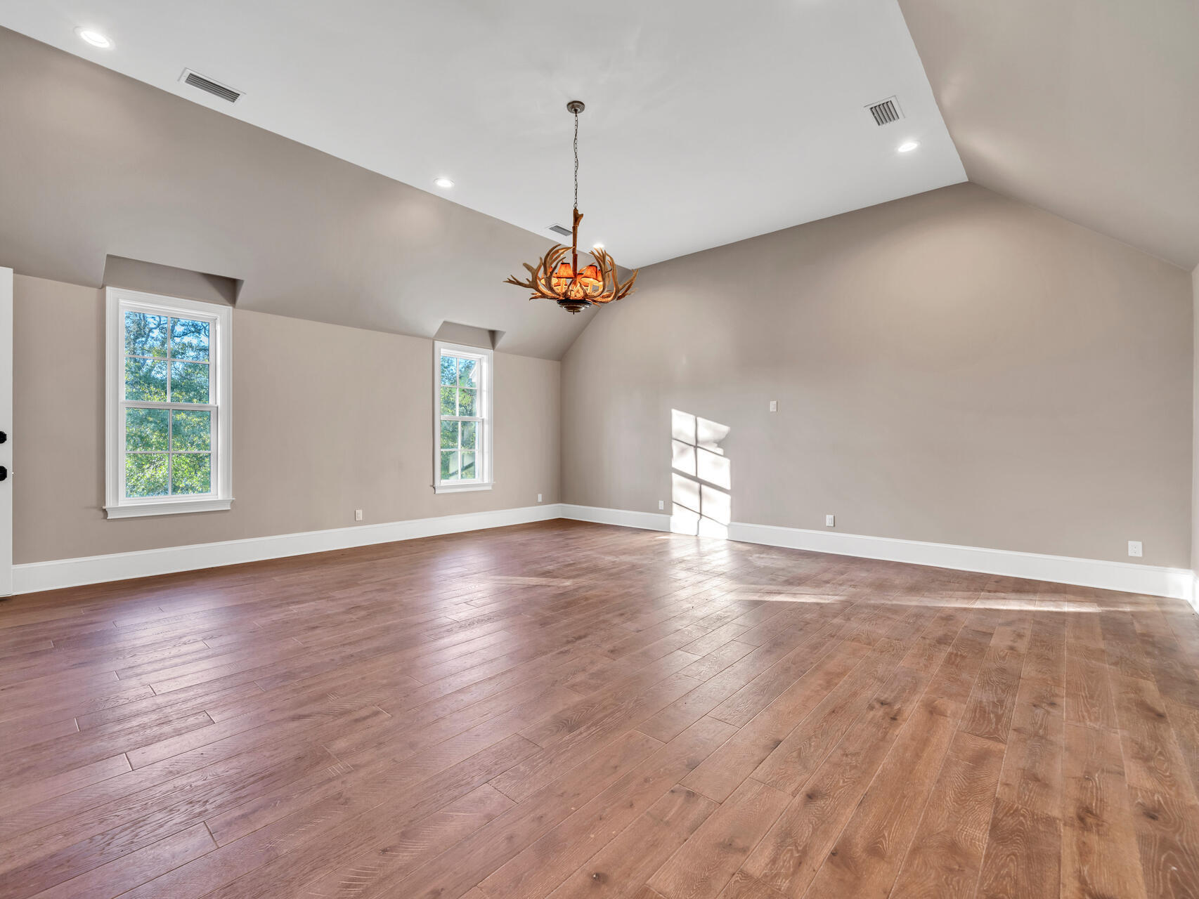 182 Buck Road Santa Rosa Beach, FL 32459 - Photo 62 of 99 an empty room with wooden floor windows and ceiling fan