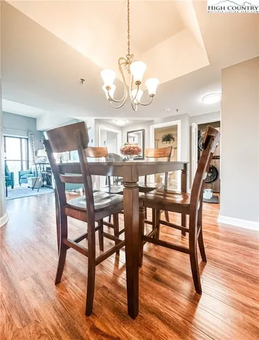 a view of a dining room with furniture wooden floor and chandelier