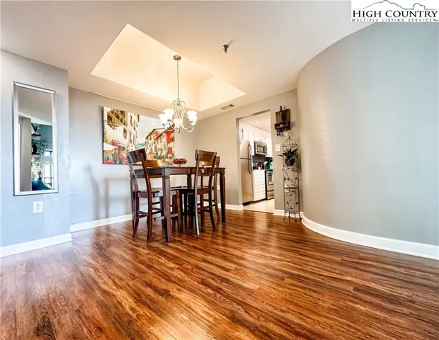 a dining room with furniture entryway and wooden floor