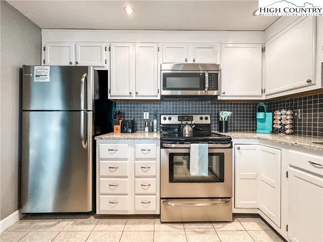 a kitchen with cabinets stainless steel appliances and a counter space