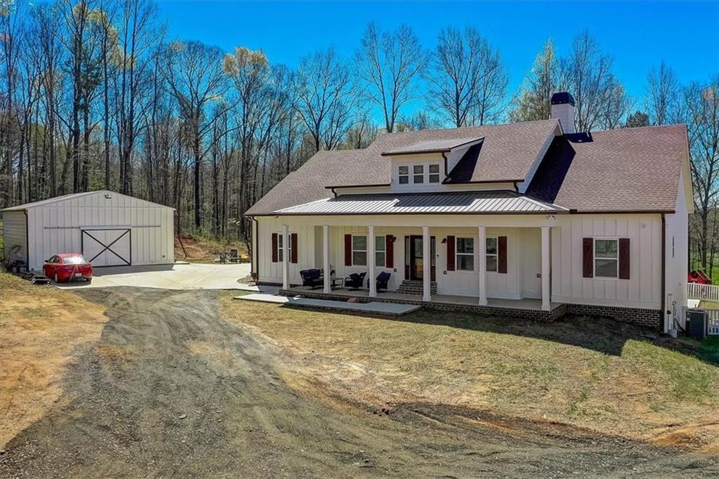 374 Geiger Road Jefferson, GA 30549 - Photo 1 of 1 a front view of a house with a yard table and chairs