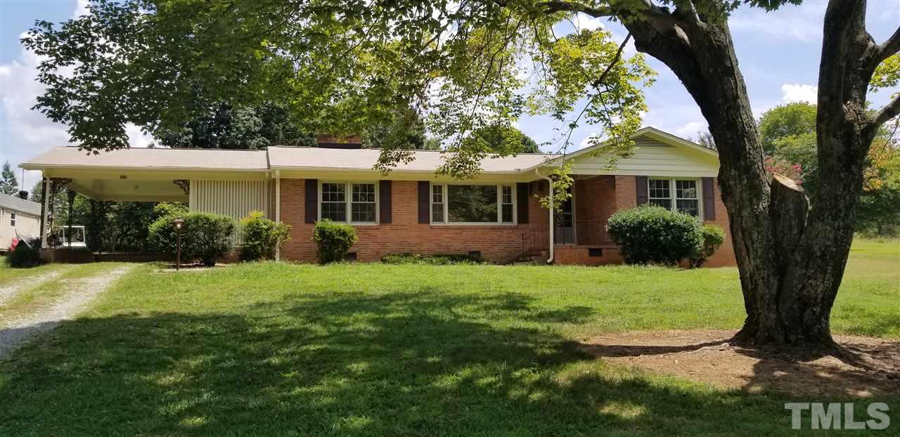 181 Henderson Road Roxboro, NC 27573 - Photo 1 of 14 a view of a house with backyard garden and plants