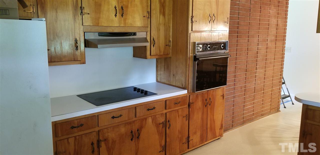 181 Henderson Road Roxboro, NC 27573 - Photo 2 of 14 a kitchen with stainless steel appliances granite countertop a stove and a refrigerator
