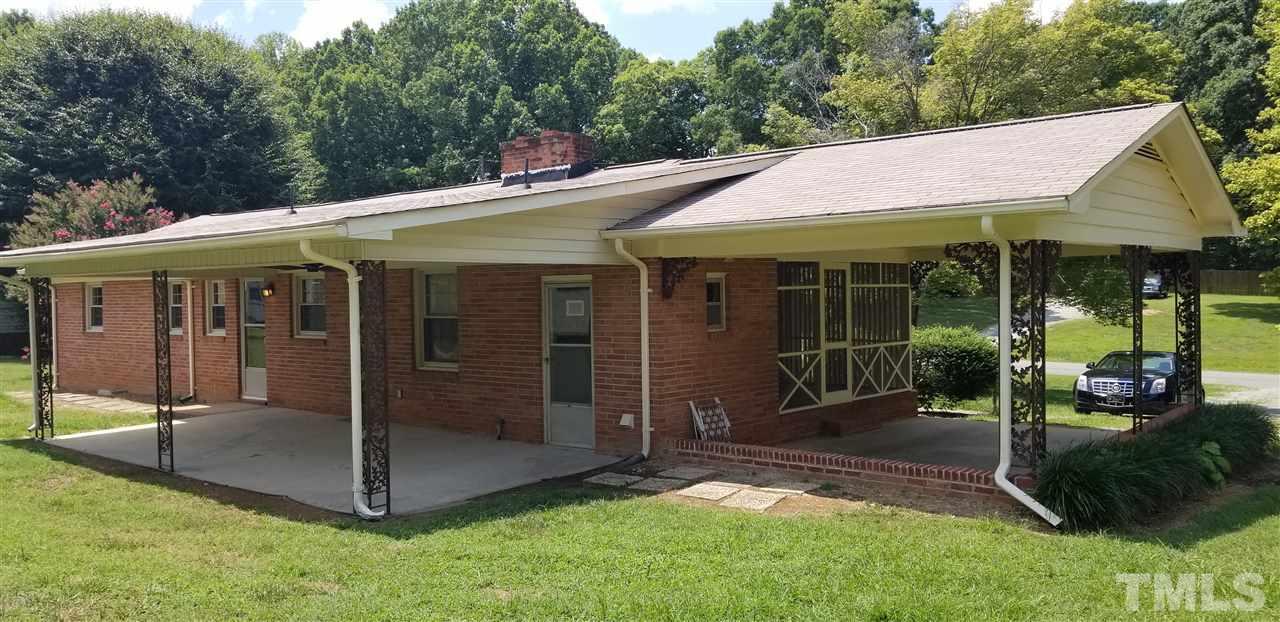 181 Henderson Road Roxboro, NC 27573 - Photo 13 of 14 a view of a patio with table and chairs under an umbrella