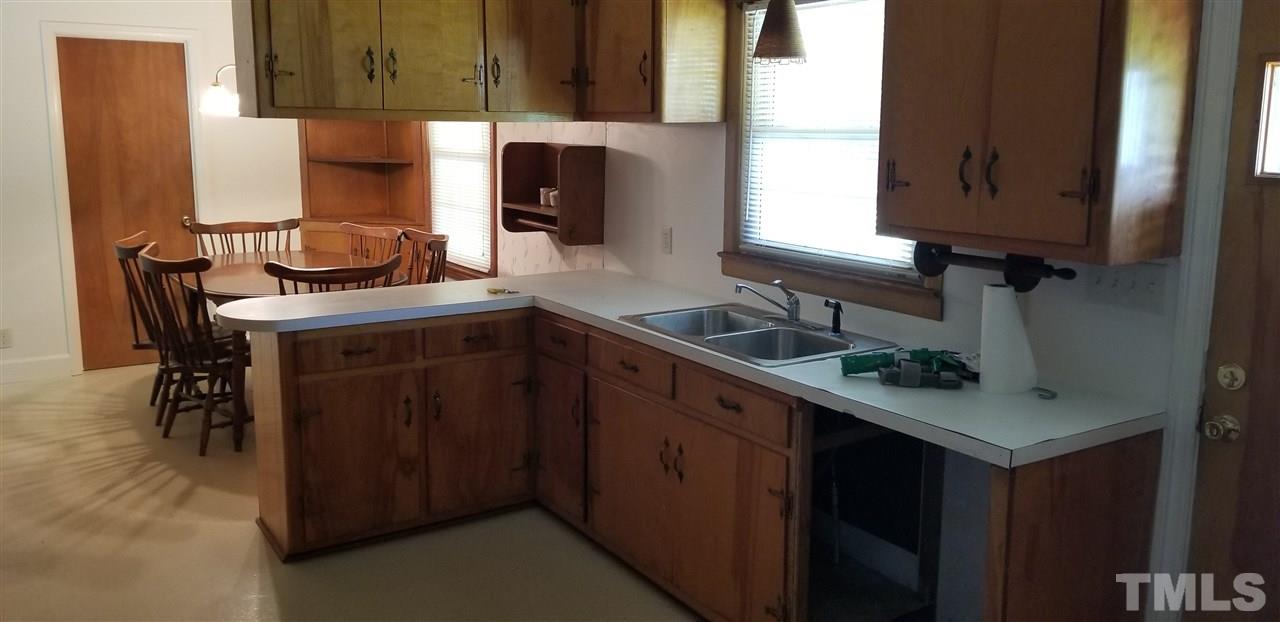 181 Henderson Road Roxboro, NC 27573 - Photo 3 of 14 a kitchen with stainless steel appliances a sink cabinets and a window