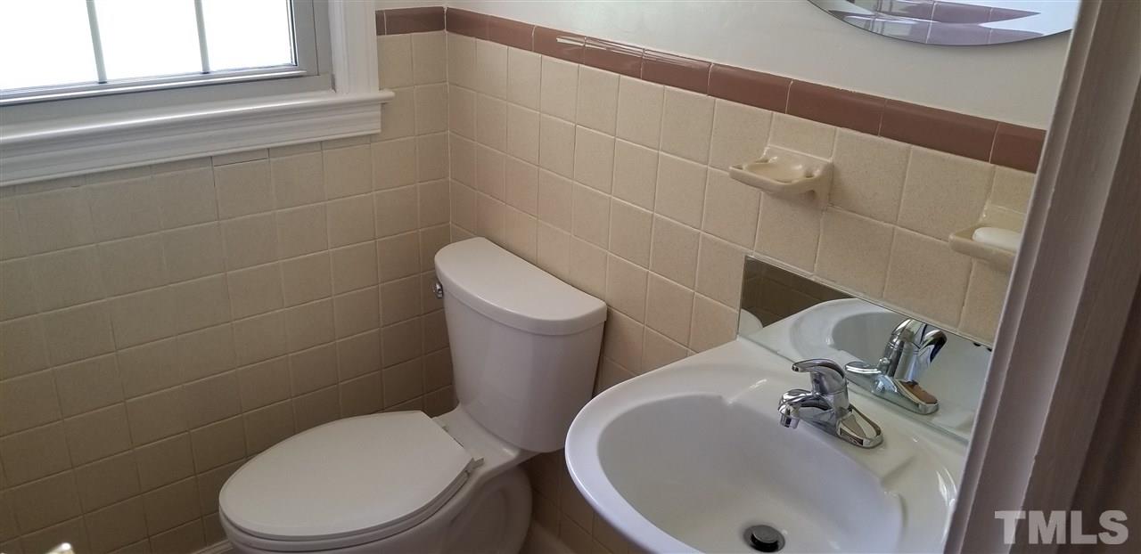 181 Henderson Road Roxboro, NC 27573 - Photo 9 of 14 a white toilet sitting next to a bathroom sink