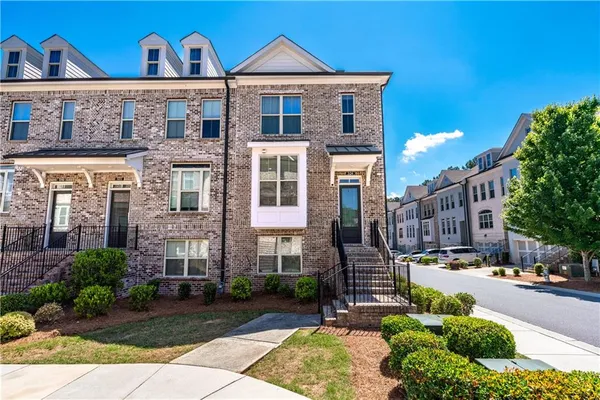 a front view of a residential apartment building with a yard
