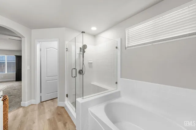 a bathroom with a bathtub and a shower